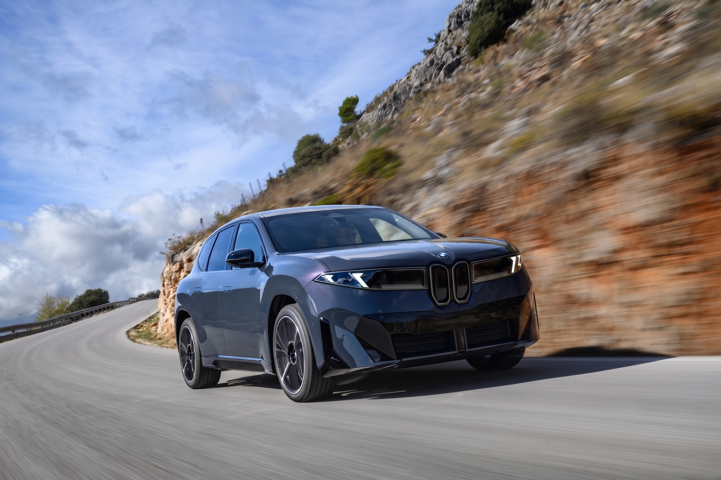 The iX3 driving at full speed around a corner.