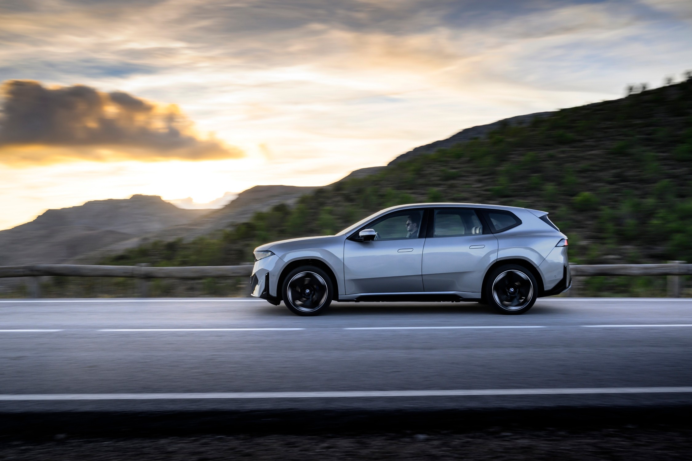 The iX3 driving between mountains.