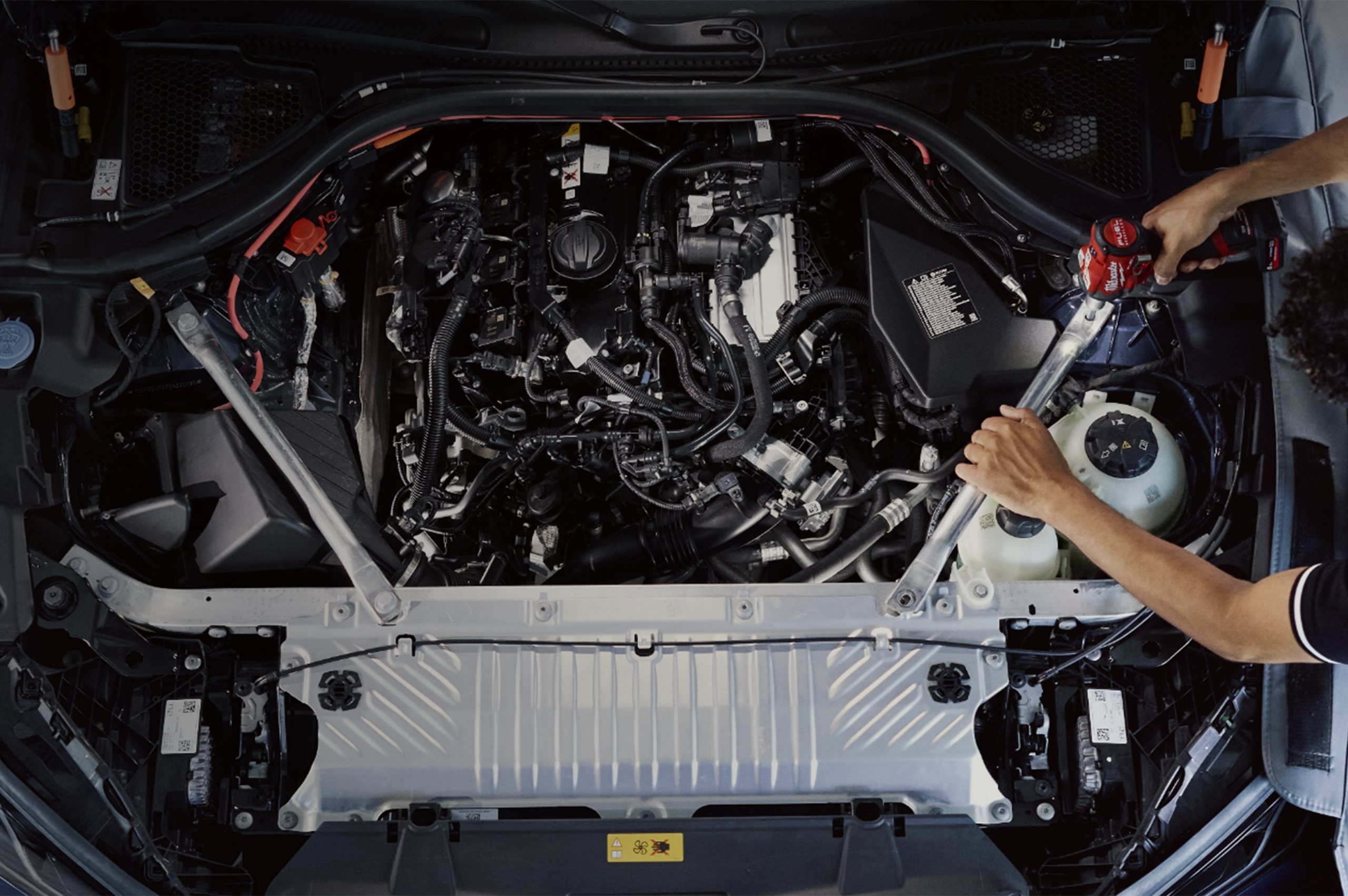 A mechanic works on a BMW.