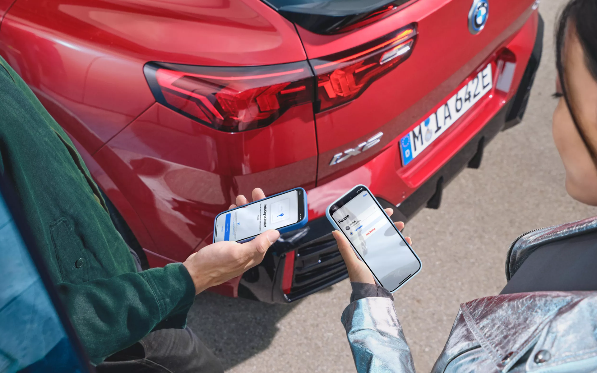 Partage sécurisé de la BMW Digital Key Plus entre deux smartphones devant un véhicule BMW