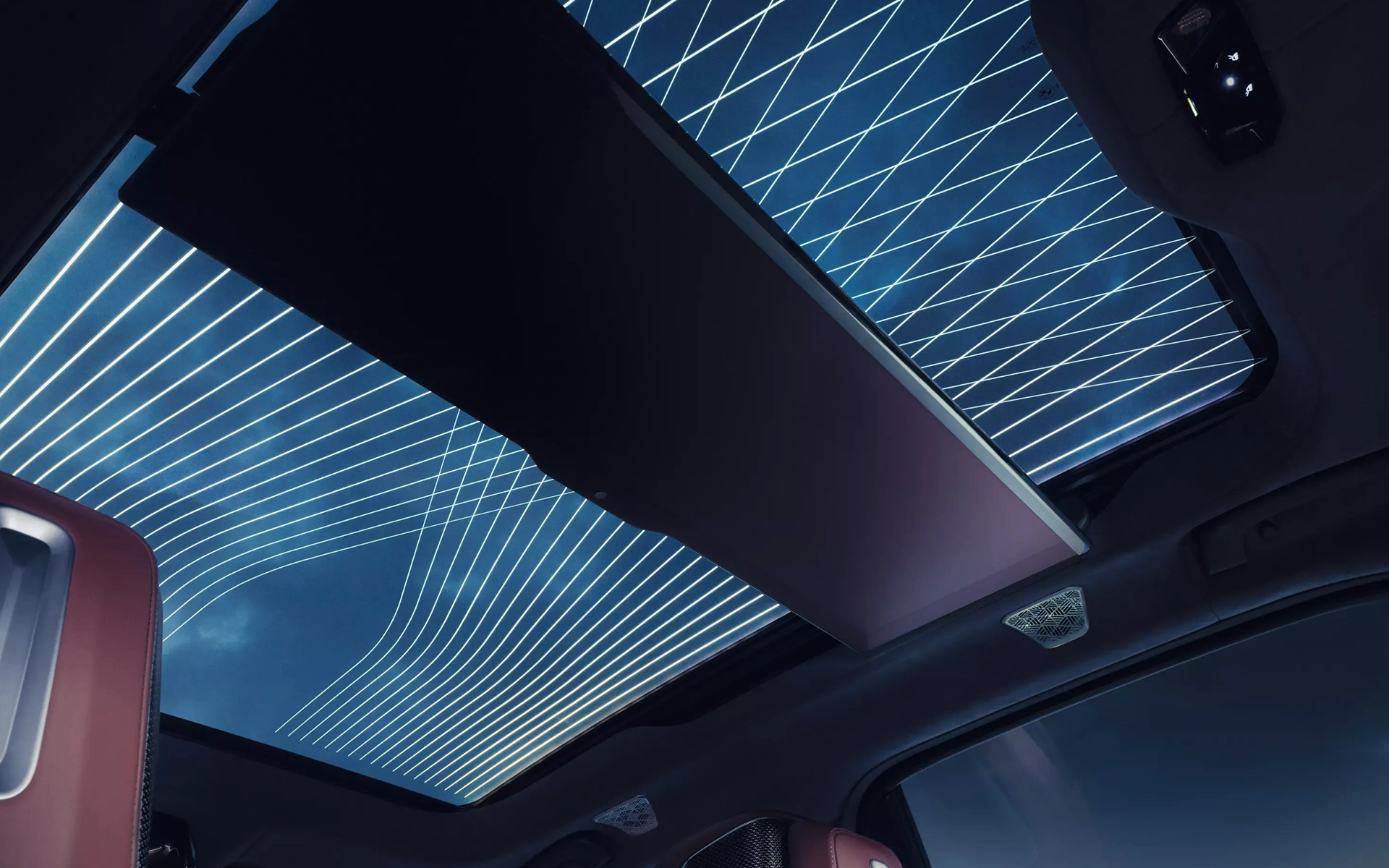 Interior view of a panoramic roof with ambient LED line lighting, featuring a futuristic design and a visible night sky.