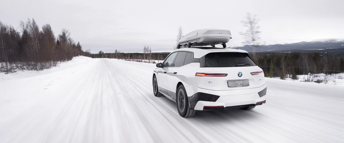 BMW iX, electric SUV, roof cargo box, winter driving, snow, xDrive traction.