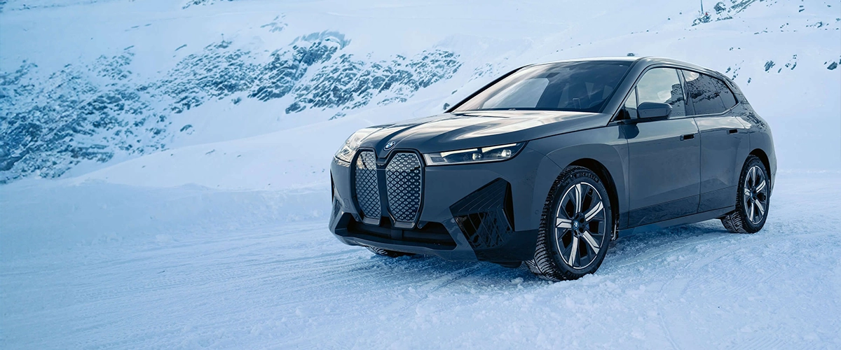BMW iX, modern design, premium SUV, snow, winter performance, xDrive technology.