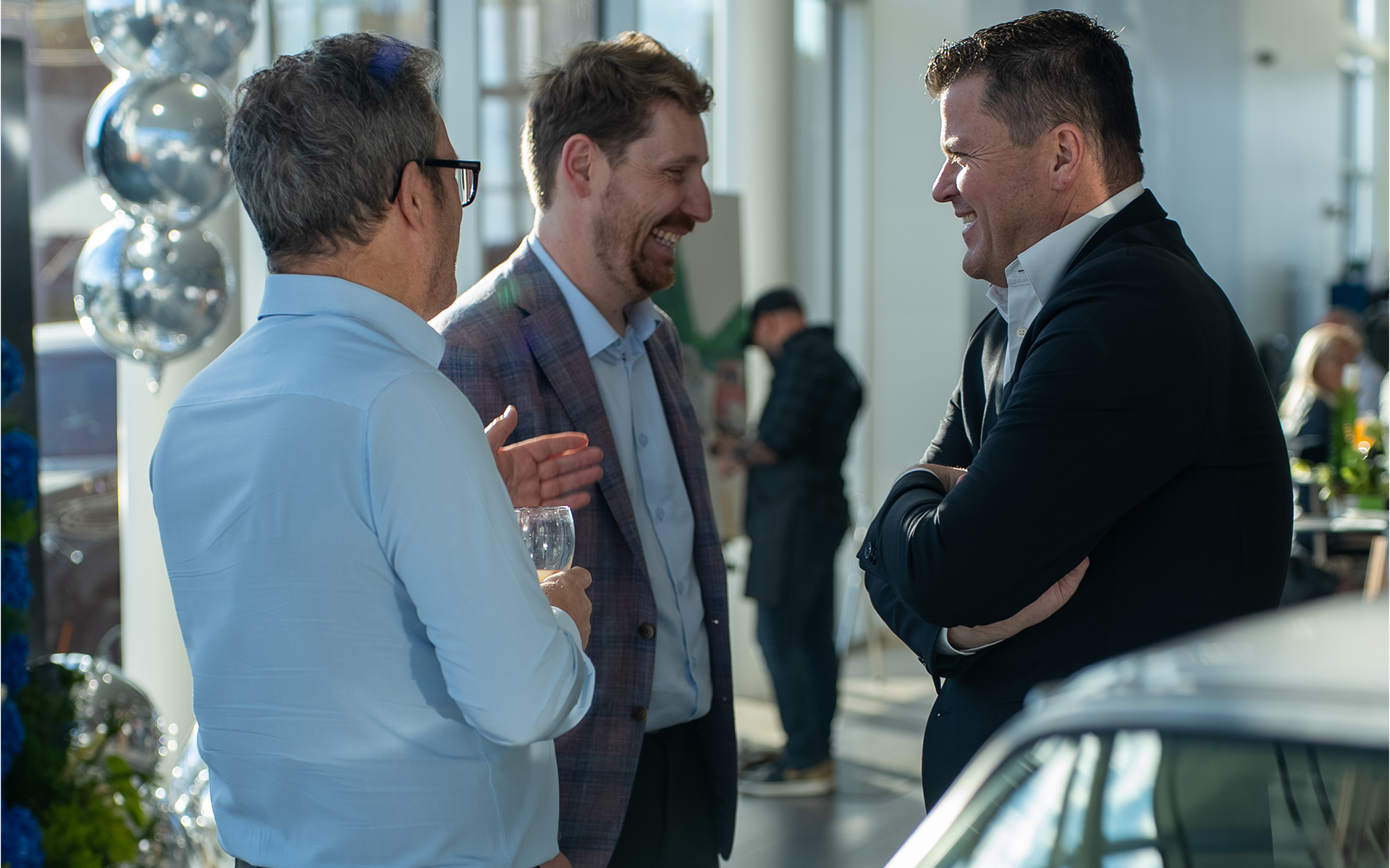 Three men chatting during the 5½-year event at BMW – MINI Ste-Agathe.